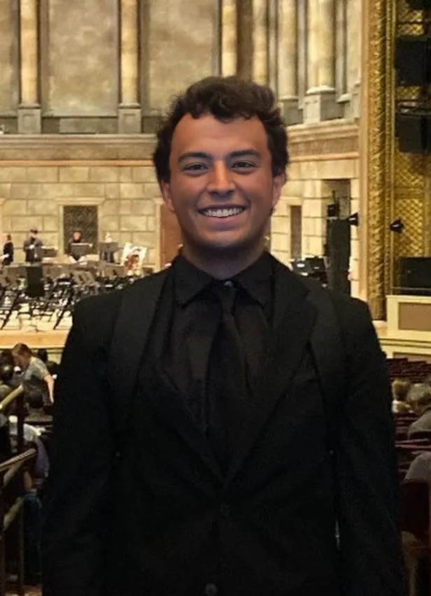 Photograph of Andre smiling at Kodak Hall in Rochester NY at the NafME All-East Band conference